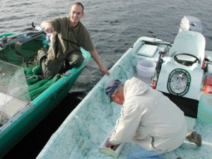 A creel clerk measures an angler's bass before returning it. (FWC photo) 