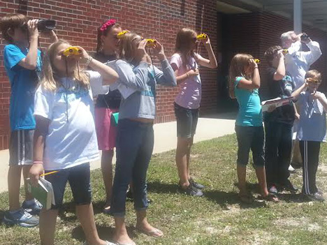 Gary Parsons, far right, shares his birding expertise with Destin Middle School students.